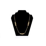 A fine modern 18ct gold necklace by Chiampesan, the twist link chain having textured beads to lower,