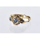 A Victorian 18ct gold sapphire and diamond ring, round cut blue stone surrounded by old cuts and