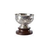 An Edwardian silver footed bowl by William & Charles Sissons, having embossed designs, London
