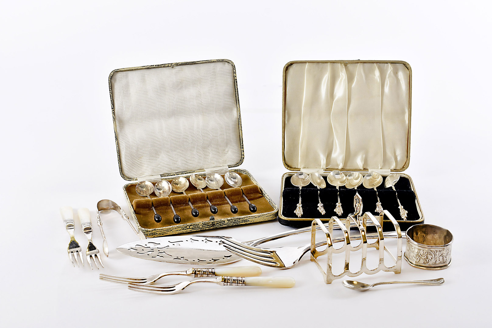 An Art Deco period silver toast rack, together with a set of silver Apostle teaspoons and matching