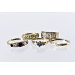 A group of five 9ct gold and gem set rings, one with Greek key design, an emerald example, a