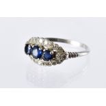 An Art Deco sapphire and diamond ring, the platinum mount having three central blue stones in a