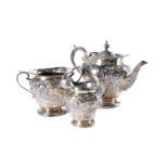 A late Victorian silver three piece tea set by HA, large form teapot, sugar basin and milk jug