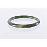 A Chinese hardstone bangle, circular in spinach jade, 7.9cm outer diameter and 6.1cm inner diameter