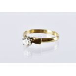 A 1970s 18ct gold and diamond solitaire engagement ring, the high claw set brilliant cut in mount