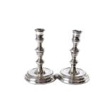 A pair of 1970s silver filled candlesticks, in the Georgian taste, one bent