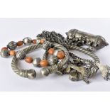 Six items of vintage North African tribal jewellery, including a short white metal and amber bead