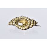 An early 19th century seed pearl and paste brooch, in the form of an eye with gold backing, 2.5cm