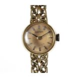 A 1960s 18ct gold Bulova lady's cocktail wristwatch, the circular case with flattened mesh link