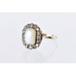 An Art Deco period opal and diamond cluster dress ring, cushion shaped stone surrounded by eight