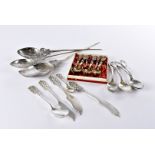 A collection of Peruvian silver and white metal flatware, including three large ornate spoons with