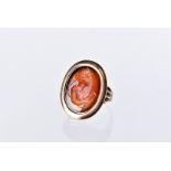 A 19th century carnelian seal signet ring, having an intaglio bust of a lady in possibly gold oval