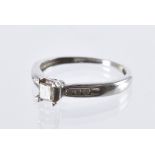A modern 9ct white gold and diamond engagement ring, having a central princess cut stone and channel