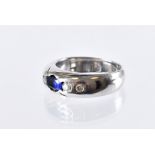 A modern 18ct white gold sapphire and diamond ring, oval blue stone and four brilliant cuts on