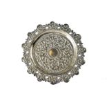 A vintage Indian white metal dish, having raised scrolling foliage designs, pierced rim, 4.85 ozt