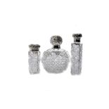 Three Victorian and later cut glass and silver capped scent bottles