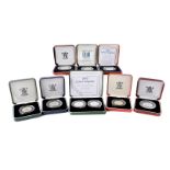 A collection of nine Royal Mint silver proof fifty pence coins, one pair, other singles, from the