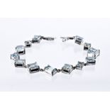 A modern 18ct white gold and aqua marine bracelet, having square and rectangular varying sized light