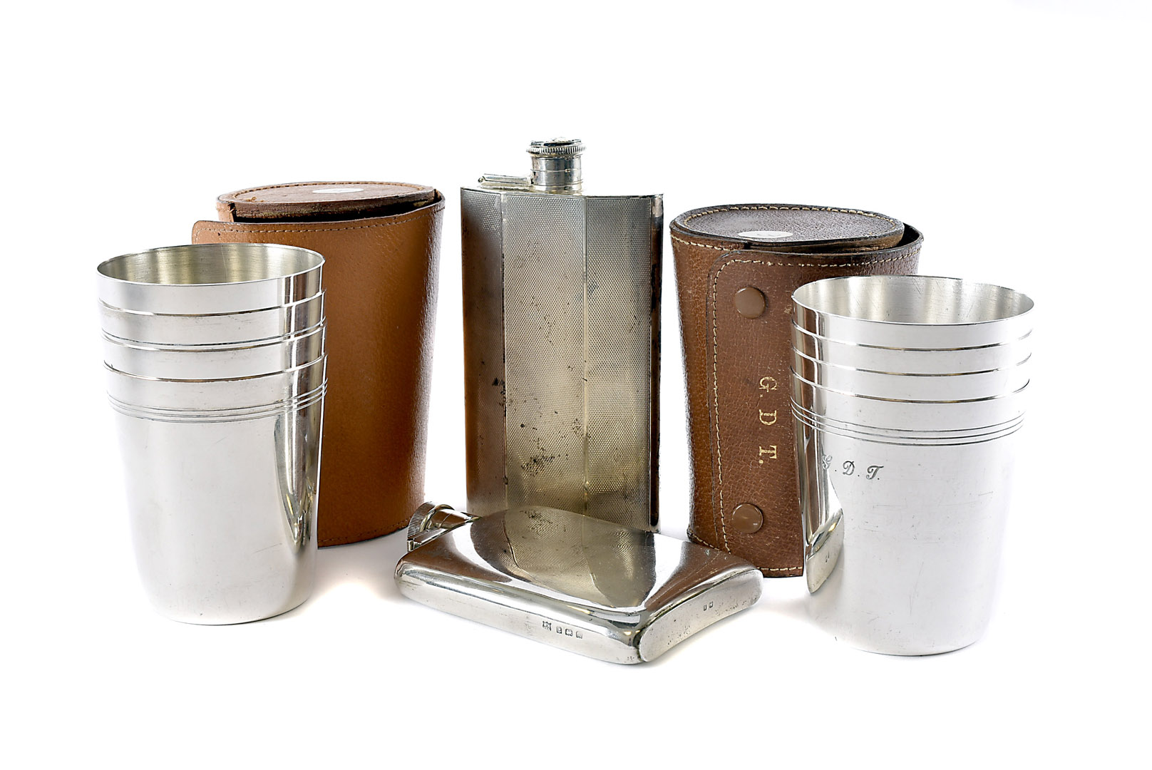 Two vintage silver hipflasks, one plain example, c1920s, and a larger engine turned example from the