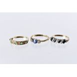 A group of three 9ct gold and gem set rings, including a sapphire and diamond three stone, an