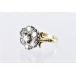 A vintage diamond cluster dress ring, the platinum flower head tablet set with seven brilliant cuts,