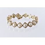 A modern 9ct gold and pearl line bracelet, diamond shaped links set with half cut white pearls,