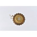 A Victorian yellow metal and diamond circular brooch, the gypsy set rough cut stones, within a