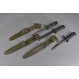 Three American combat bayonets, comprising the US M4 Imperial hard rubber grip bayonet knife, the US