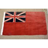A vintage British Red Ensign flag, approx 61cm x 108cm, with wear