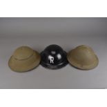 A WWII black painted brodie helmet with 'R' painted to either side, with impress mark BMB 1943 T721,
