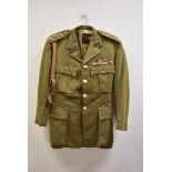A No.2 Battledress, having over shoulder leather strap, with numerous buttons and badges to