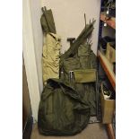 An extensive assortment of military camping items, including camp beds, one wooden framed the others