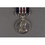 A George V Military medal, with uncrown King to one side and 'For Bravery in the Field' to the