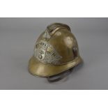 An early 20th Century French brass Adrian fireman's helmet, of the Sapeurs Pompiers de Carhaix,
