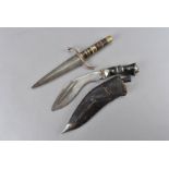 A small double sided dagger, with copper hand guard, with mixed medium handles, together with a