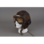 A WWII period brown leather flying helmet, having markers stamp to inside, but has worn over time,