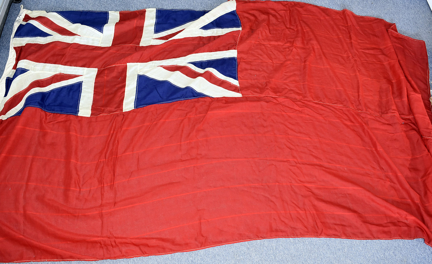 A late 19th century/early 20th century large British Red Ensign flag, all hand stitched, marked