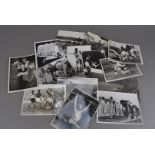 An assortment of military and sporting press photos and postcards, most of the black and white