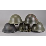 A collection of WWII period and later British Turtle helmets, including one marked SGT S/2 to the