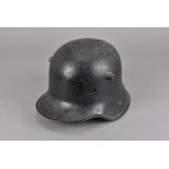 A WWII Third Reich M16 helmet, in black, with impress 'G62' to underside, missing liner