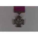 A copy of a Victoria Cross, on purple ribbon