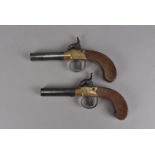 A pair of 19th century Hollis percussion cap pistols, having engraved brass body, with steel