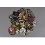 A collection of various military badges and buttons, comprising Army, Naval and RAF, including Royal