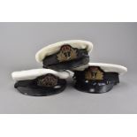 Three WWII British Naval peak caps, all with bullion cap badges, two hats possibly later (3)
