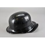 A WWII Third Reich Fire helmet, the black helmet with black leather neck protector, original leather