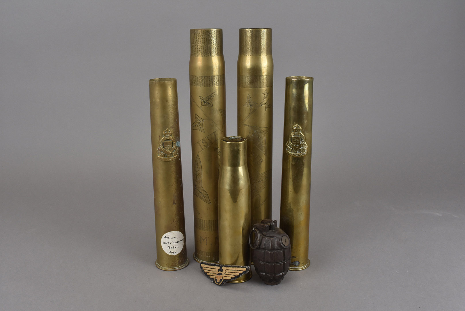 A pair of WWI engraved trench art shells, one dated 1917 and the other 1918, together with three