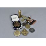 An assortment of Third Reich medals and badges, comprising Olympic medal 1936, Naval League Fleet,