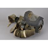 A WWII babies gas mask, marked V.R.C. 6-42 Lot 254, together with three small boxed gas masks, of