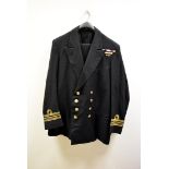 A Lieutenant Commander Naval jacket and trousers, having numerous medal ribbons, one with oak