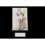 Betty Grable / Autograph, a black and white photograph of Betty mounted above a paper sheet